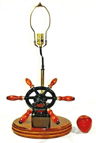 Vintage Ships Wheel Table Lamp  Vintage ships wheel table lamp, has been lovingly reconditioned. Wood base with  decorative rope trim, metal and wood  ship wheel, year 1960's, three-way light,  very good condition. Please see photos.  Measurements: 26" Tall To Top Of Harp 12 1/4" Wood Base Side To Side 13" Wood Base Front To Back Including The Wheel  Note: If you have any questions or concerns about the Vintage Ships Wheel Table Lamp, please contact us.
