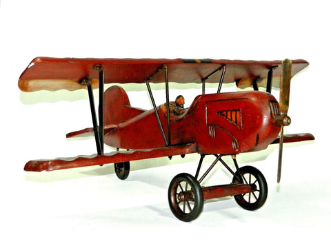 Vintage Wood Carved Biplane  Vintage wood carved biplane, with fighter pilot, very good condition. Please see photos.  Measurements: 30” Wide Wing Span 27” Long Tail To Propeller 13” Tall  Note: I will take the plane apart to ship. No tools are required to assemble.